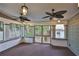 Charming porch with fans, screened doors, and views of the surrounding yard at 1825 2Nd S St, St Petersburg, FL 33705