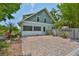 Side exterior showing a well maintained fence and a large brick area at 1825 2Nd S St, St Petersburg, FL 33705