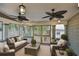 Inviting sunroom with wicker furniture, ceiling fans, neutral decor, and plenty of natural light at 1825 2Nd S St, St Petersburg, FL 33705