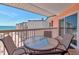 Balcony with table and four chairs with partial view of ocean at 18400 Gulf Blvd # 2505, Indian Shores, FL 33785