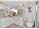Bright bathroom with double sink vanity, decorative mirror, decorative fish and walk-in shower at 18400 Gulf Blvd # 2505, Indian Shores, FL 33785