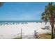 Expansive beach view featuring blue umbrellas and clear skies, perfect for relaxation and coastal living at 18400 Gulf Blvd # 2505, Indian Shores, FL 33785