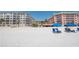 Relaxing beach scene with colorful condos as backdrop, featuring beach chairs for leisurely enjoyment at 18400 Gulf Blvd # 2505, Indian Shores, FL 33785
