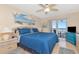 Bright bedroom featuring a king bed, beach mural and a sliding glass door to a balcony with ocean view at 18400 Gulf Blvd # 2505, Indian Shores, FL 33785