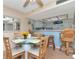 Dining area featuring seating for four and views into the kitchen at 18400 Gulf Blvd # 2505, Indian Shores, FL 33785