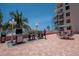 Outdoor grilling area with multiple grills, picnic tables, and beach views at 18400 Gulf Blvd # 2505, Indian Shores, FL 33785