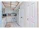 Kitchen with white cabinets, white appliances, and overhead lighting at 18400 Gulf Blvd # 2505, Indian Shores, FL 33785