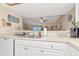 Bright kitchen featuring stainless steel sink and white cabinets at 18400 Gulf Blvd # 2505, Indian Shores, FL 33785