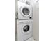 Stackable white washer and dryer in laundry area of home at 18400 Gulf Blvd # 2505, Indian Shores, FL 33785