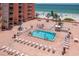 Aerial view of the outdoor pool and lounge area with stunning views of the ocean at 18400 Gulf Blvd # 2505, Indian Shores, FL 33785