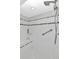 White tile shower with built in bench and grab bar at 18400 Gulf Blvd # 2505, Indian Shores, FL 33785