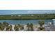 Scenic waterfront property with lush greenery, palm trees, and tranquil water views at 18400 Gulf Blvd # 2505, Indian Shores, FL 33785