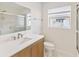 Bright bathroom featuring a new vanity, updated fixtures, and shower with glass doors at 2016 Cove Dr, Largo, FL 33774