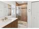 Modern bathroom featuring a glass-enclosed shower, vanity with sink, and decorative tiles at 2016 Cove Dr, Largo, FL 33774