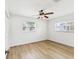 Bedroom with wood flooring, impact windows and a ceiling fan at 2016 Cove Dr, Largo, FL 33774