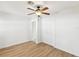 Bedroom with wood floors, ceiling fan, and a double-door closet at 2016 Cove Dr, Largo, FL 33774