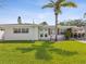Charming single-story home with a well-maintained lawn and tropical landscaping at 2016 Cove Dr, Largo, FL 33774