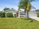 Charming single story home featuring a well-manicured lawn and lush landscaping at 2016 Cove Dr, Largo, FL 33774
