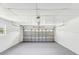 Spacious two-car garage with painted walls, lighting and garage door leading to driveway at 2016 Cove Dr, Largo, FL 33774