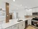 Modern kitchen with stainless steel appliances, quartz countertops, and bright lighting at 2016 Cove Dr, Largo, FL 33774
