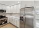 Beautiful kitchen featuring stainless steel appliances, bright white cabinets, and quartz countertops at 2016 Cove Dr, Largo, FL 33774
