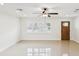 Bright living room featuring tile floors, a ceiling fan, and natural light from large window at 2016 Cove Dr, Largo, FL 33774