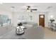 Bright living room boasts a ceiling fan, neutral tones, and floods of natural light at 2016 Cove Dr, Largo, FL 33774