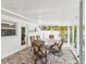 Covered patio has brick floors and a dining set at 2016 Cove Dr, Largo, FL 33774