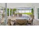 Covered patio with brick floors, dining set, and views of the backyard at 2016 Cove Dr, Largo, FL 33774