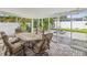 Covered patio with dining set and views of the backyard firepit at 2016 Cove Dr, Largo, FL 33774