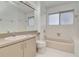 Bathroom featuring a tub, neutral vanity with sink, and a toilet at 2120 S Hesperides St, Tampa, FL 33629