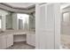 Spacious bathroom featuring double sinks, mirrored walls, and a separate shower and tub at 2120 S Hesperides St, Tampa, FL 33629