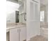 This bathroom features a spacious vanity, cabinet, a large mirror, and a soaking tub at 2120 S Hesperides St, Tampa, FL 33629