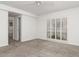Bright bedroom with neutral carpet, white walls, ceiling fan and shuttered windows at 2120 S Hesperides St, Tampa, FL 33629