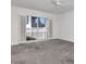 Bedroom with white walls, gray carpet, ceiling fan, and shuttered sliding glass door at 2120 S Hesperides St, Tampa, FL 33629