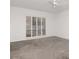 Bright bedroom featuring neutral carpet, a ceiling fan, and a large window with shutter blinds at 2120 S Hesperides St, Tampa, FL 33629