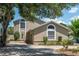 A charming home with a well-maintained front yard and a paved driveway, perfect for curb appeal at 2120 S Hesperides St, Tampa, FL 33629