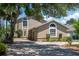 Charming two-story home featuring an attached garage, well-maintained landscaping, and arched windows at 2120 S Hesperides St, Tampa, FL 33629