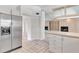 Bright kitchen featuring stainless steel refrigerator, tile floors, and white cabinets at 2120 S Hesperides St, Tampa, FL 33629