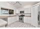 Modern kitchen featuring stainless steel appliances, white cabinets, tile floors, and ample counter space at 2120 S Hesperides St, Tampa, FL 33629