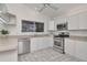 Bright kitchen features stainless steel appliances, white cabinetry, and a window view to the pool at 2120 S Hesperides St, Tampa, FL 33629