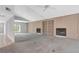 Open living room with light wood paneling, built-in bookshelves, and a cozy fireplace, perfect for relaxing at 2120 S Hesperides St, Tampa, FL 33629