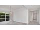 A spacious living room is brightened by a large window looking out to a lush garden at 2120 S Hesperides St, Tampa, FL 33629