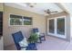 Relaxing covered patio featuring comfortable rocking chairs and a ceiling fan for outdoor enjoyment at 2120 S Hesperides St, Tampa, FL 33629