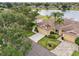 Aerial view showcases the home's desirable location with lush landscaping and a large driveway at 2218 Brookfield Greens Cir # 82, Sun City Center, FL 33573