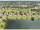 Scenic aerial view capturing the golf community homes surrounding a serene lake at 2218 Brookfield Greens Cir # 82, Sun City Center, FL 33573