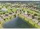 Aerial view of the golf community with picturesque homes and direct lake access at 2218 Brookfield Greens Cir # 82, Sun City Center, FL 33573