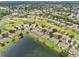 Wide aerial view highlighting golf community homes surrounded by manicured fairways and serene lakes at 2218 Brookfield Greens Cir # 82, Sun City Center, FL 33573