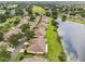 Aerial view of home situated on lake showcasing the private backyard and lanai at 2218 Brookfield Greens Cir # 82, Sun City Center, FL 33573