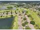 Expansive aerial view of a lush golf course community featuring well-manicured lawns, serene ponds, and beautiful single-Gathering homes at 2218 Brookfield Greens Cir # 82, Sun City Center, FL 33573